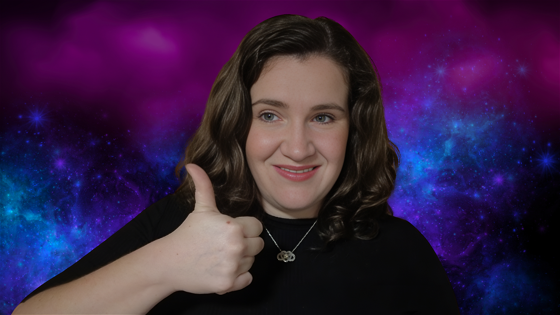 A person with wavy brown hair gives a thumbs up and smiles, wearing a black top and a silver necklace, with a vibrant purple and blue galaxy background.