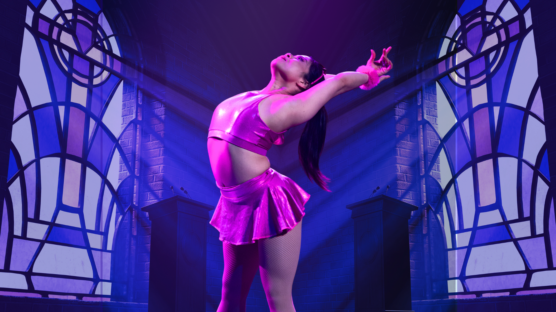 A dancer in a shiny pink outfit poses gracefully with arms stretched back in a dramatic, purple-lit room with large arched windows and geometric patterns behind her.